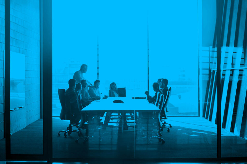 CEO giving peptalk to businesspeople at meeting in big conferenceroom